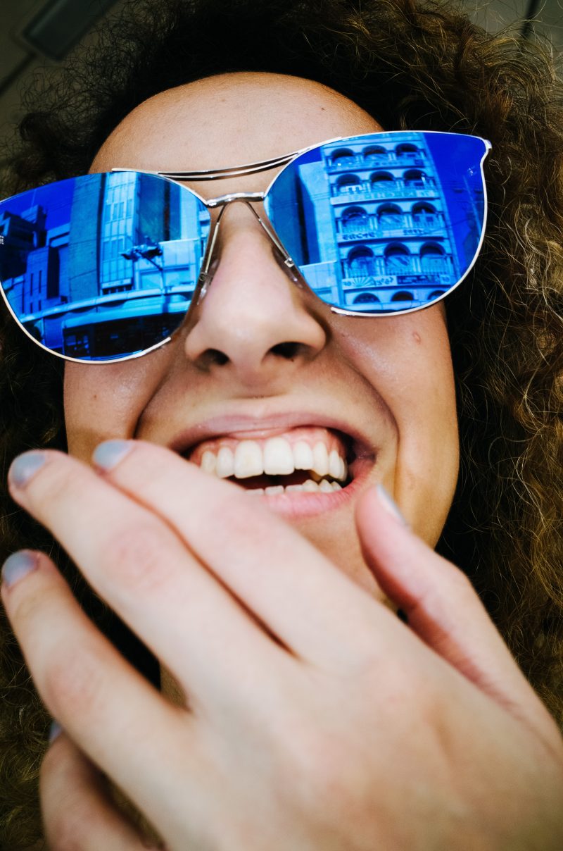 Girl laughing with blue sunglasss. Kyoto, 2017.
