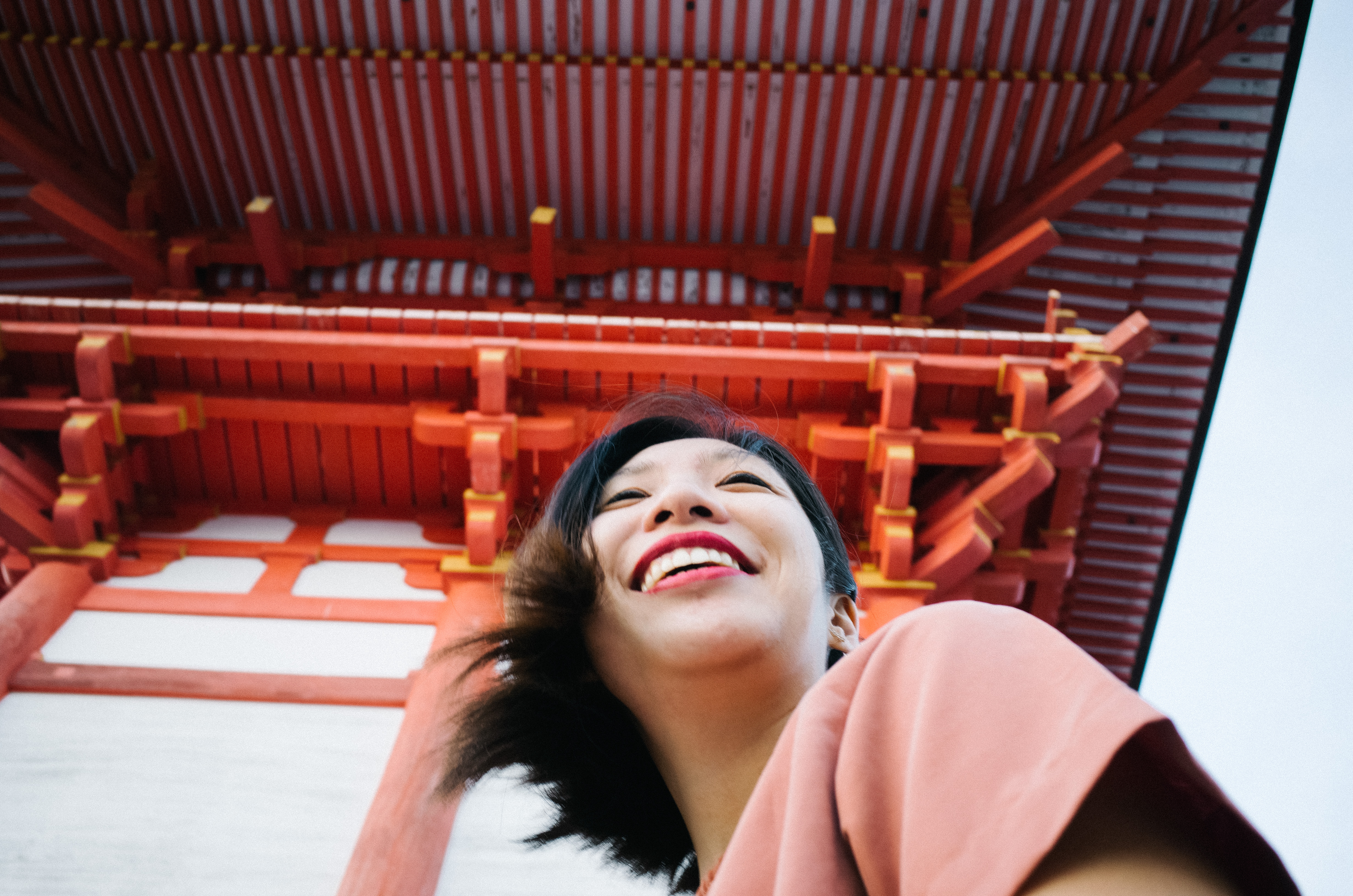 Cindy laughing at red shrine. Kyoto, 2017.