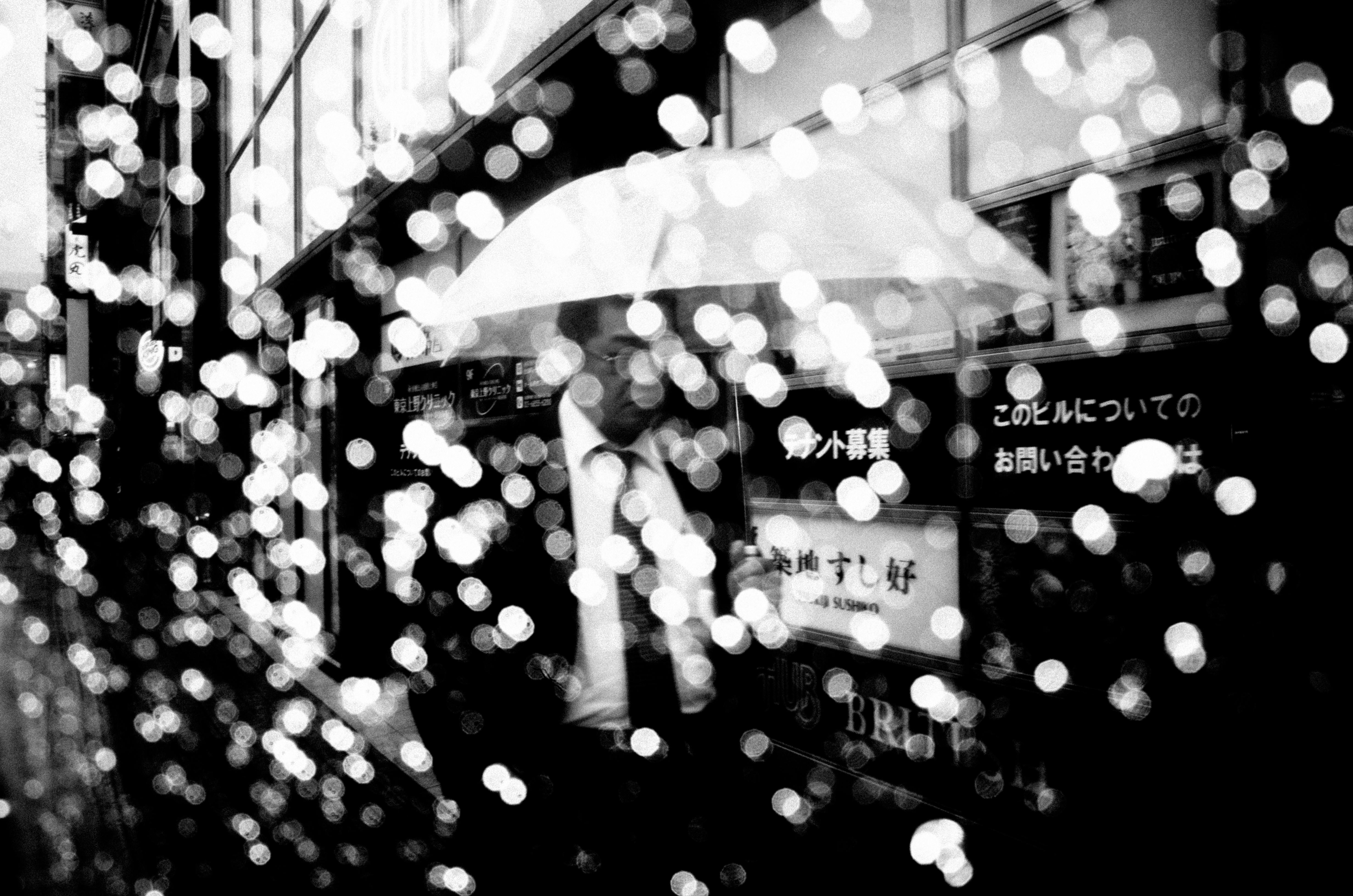 DARK SKIES OVER TOKYO / Man with umbrella.