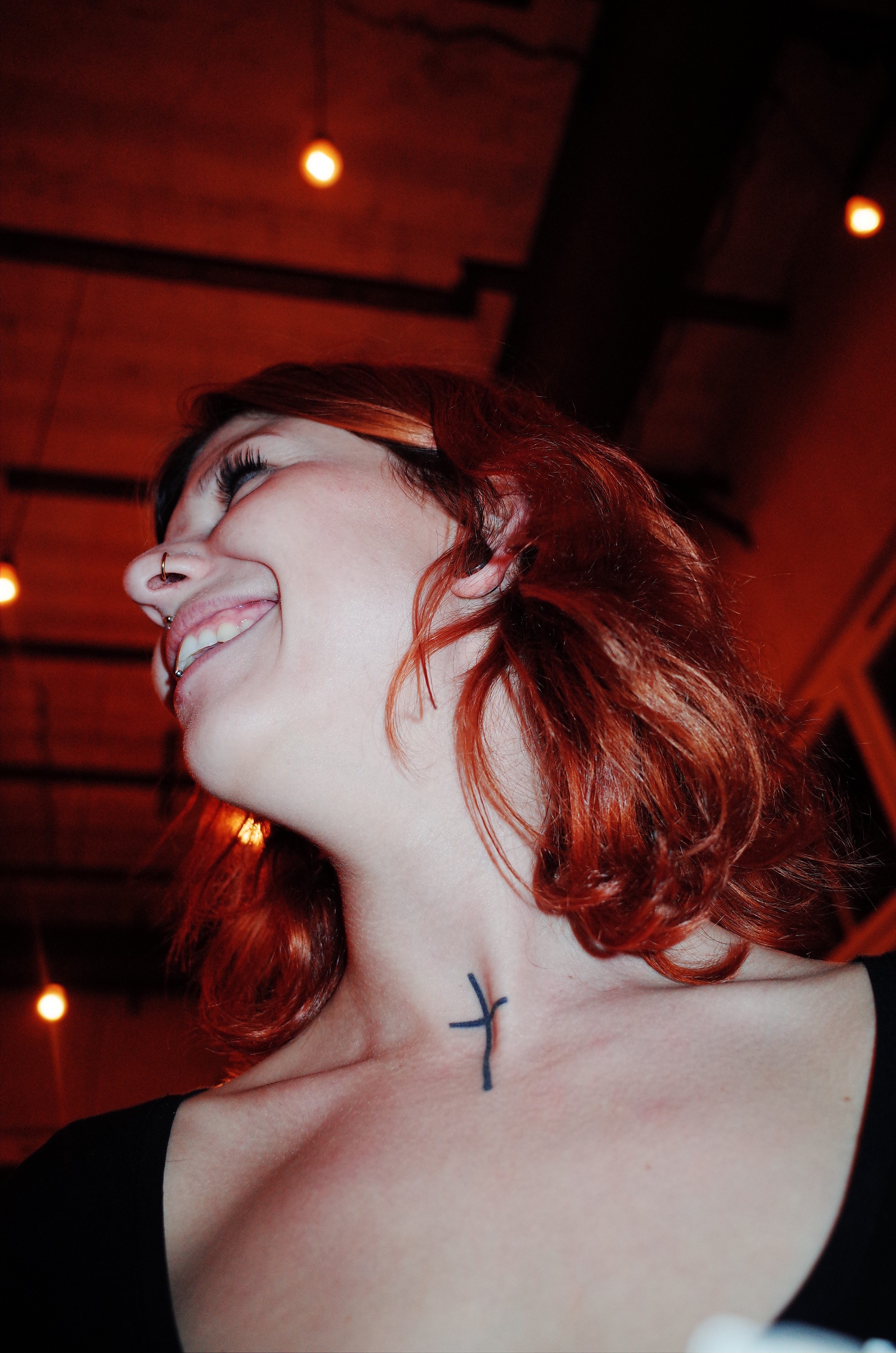 Woman with cross neck tattoo. Berlin, 2017