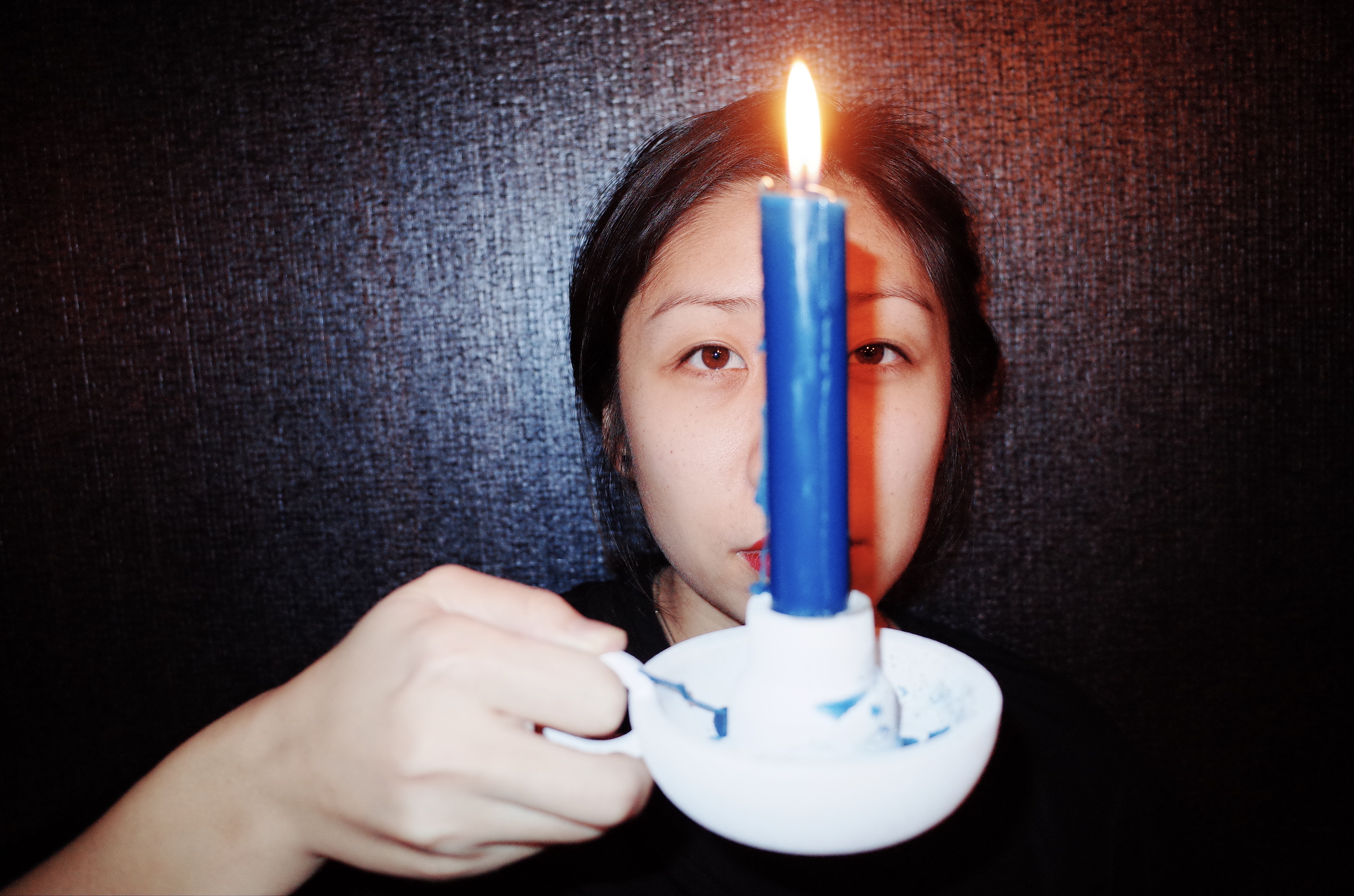 Cindy with blue candle over face. Marseille, 2017