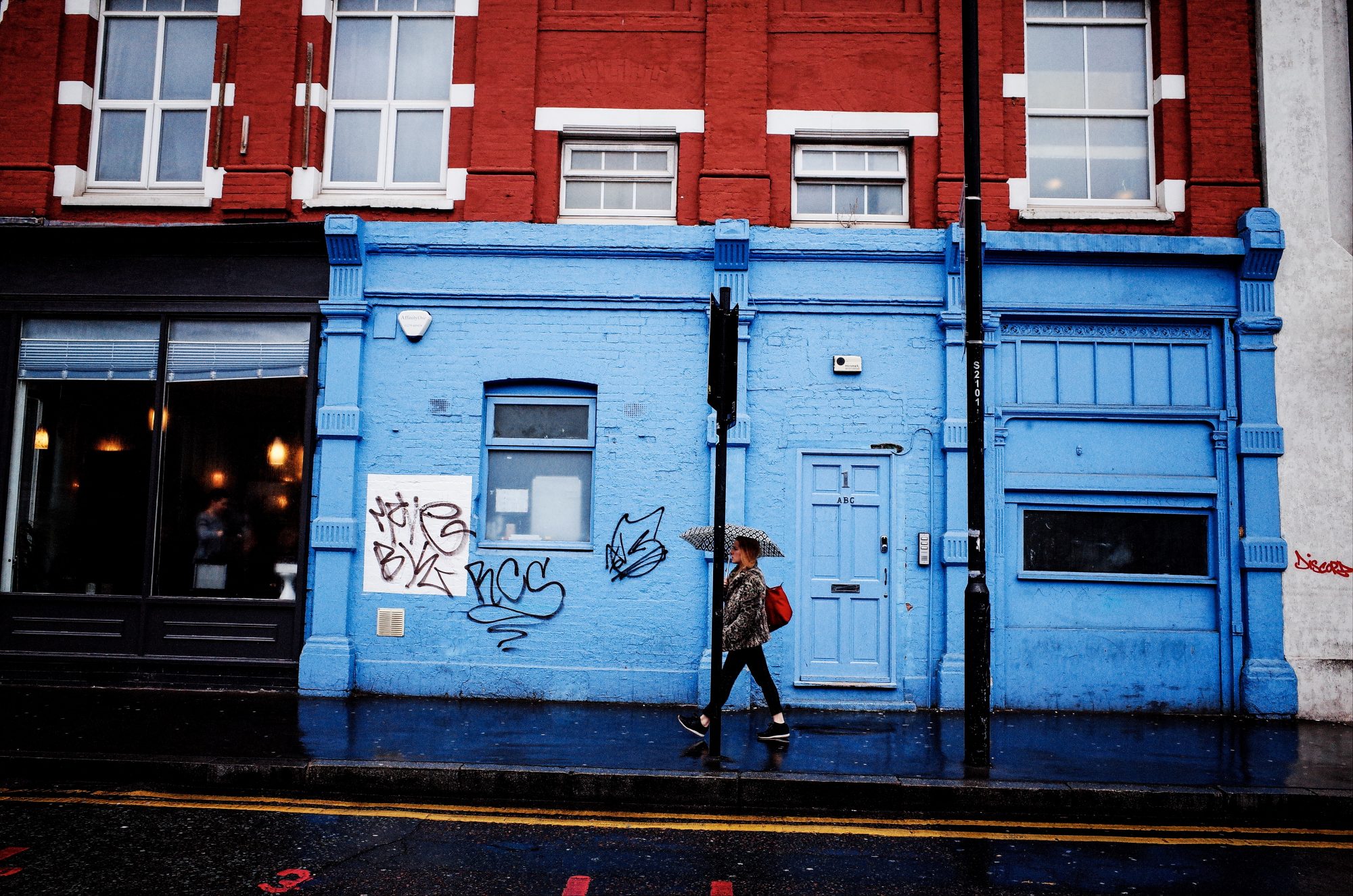 Red, blue, woman walking. London, 2018