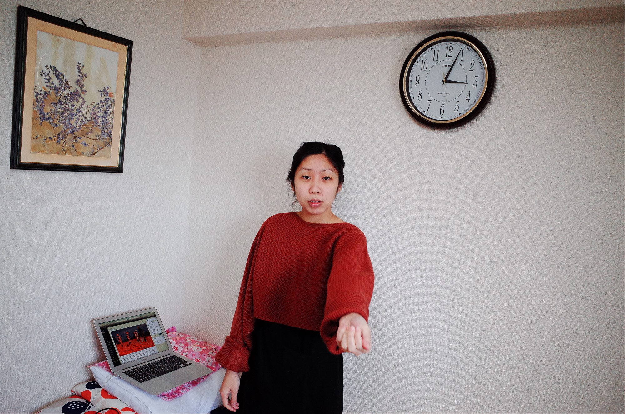 Cindy in living room, with clock in background. Osaka, 2018