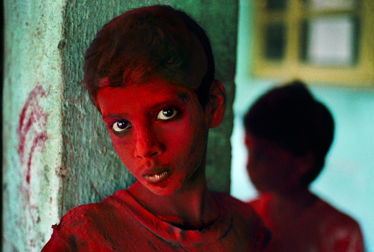 INDIA. Mumbai (Bombay). 1996. Red Boy during Holi festival.